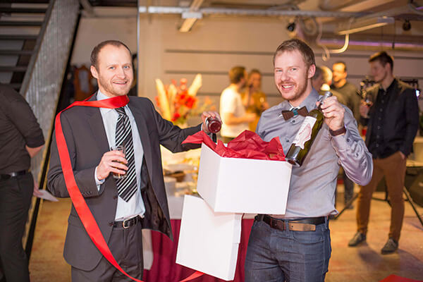 The company executives, Karel and Arni, are opening a gift.